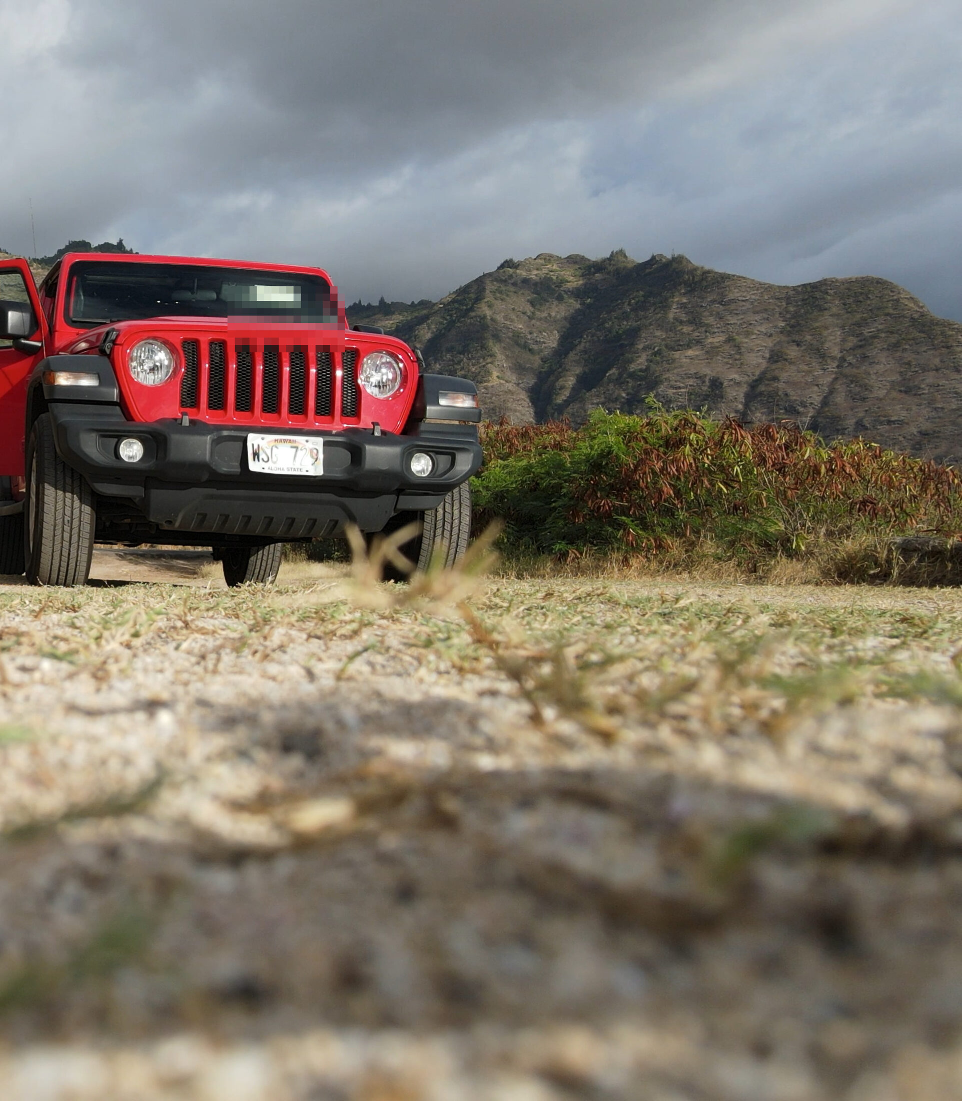Red 4x4 low-angle detail in storm light