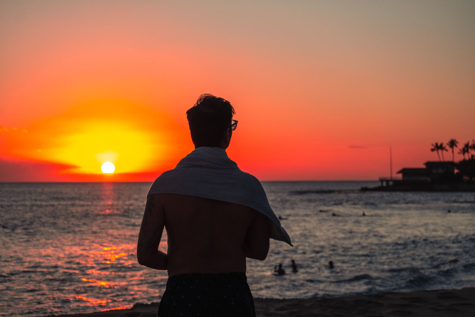 Silhouette watching the sun drop into the Pacific
