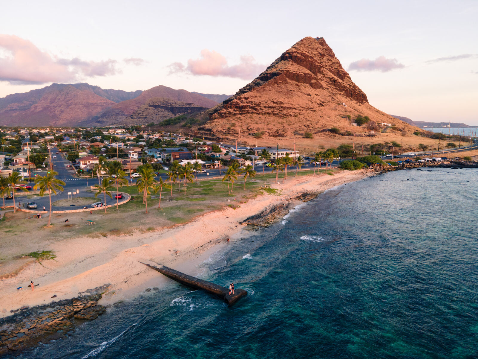 Aerial of a volcanic peak above a coastal town
