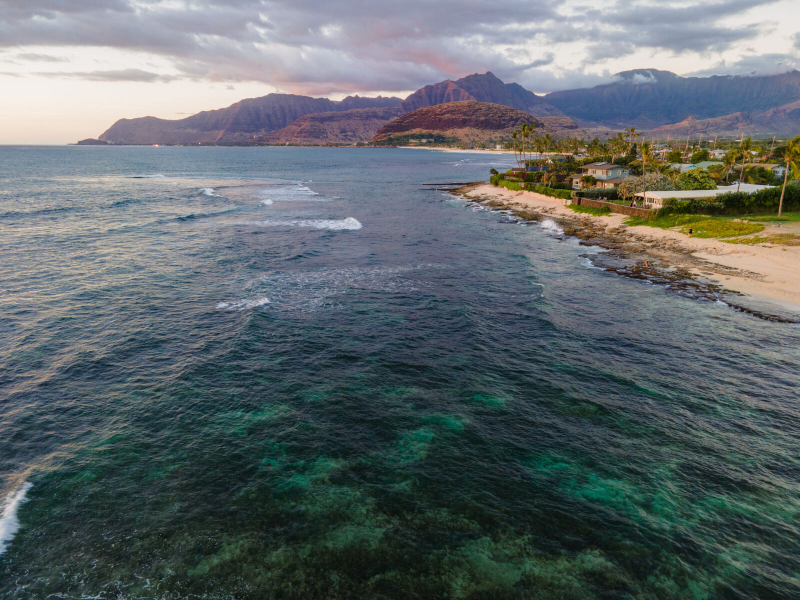 Aerial of reef and coastline at dusk