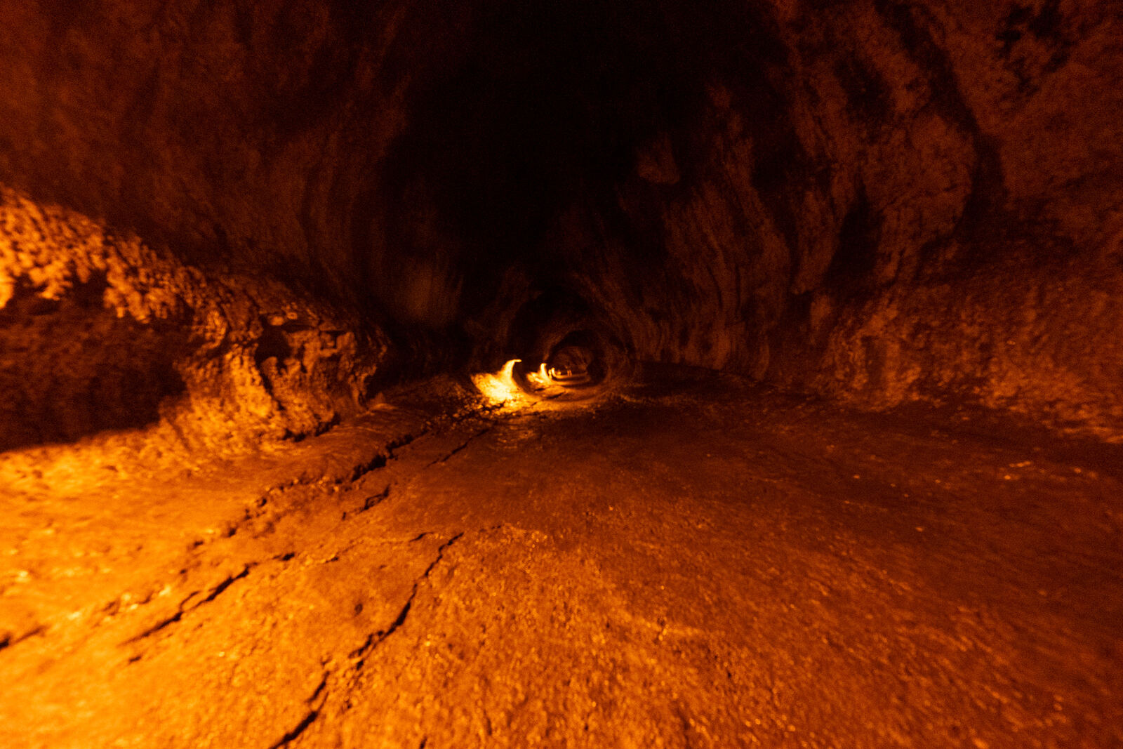 Inside a lava tube lit warm