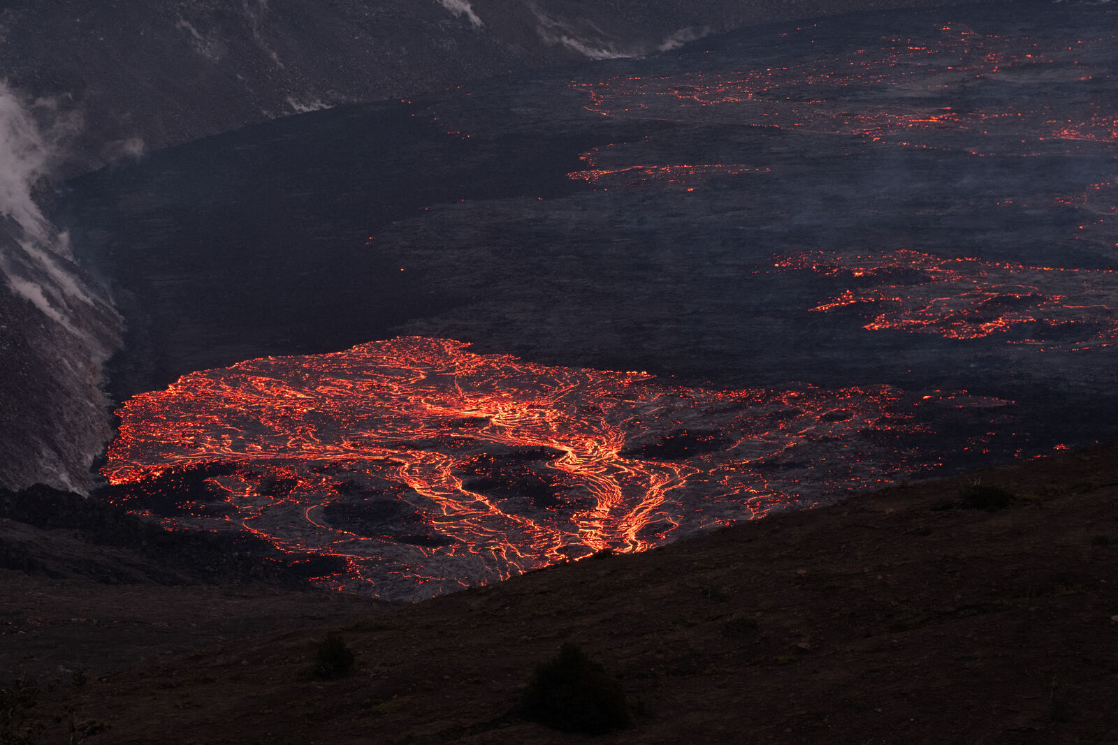 Molten lava lake glowing in a volcanic crater