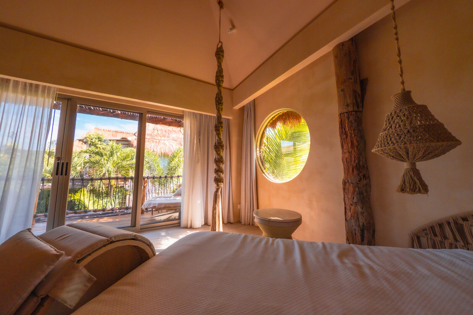 Warm boutique suite with balcony and palm view
