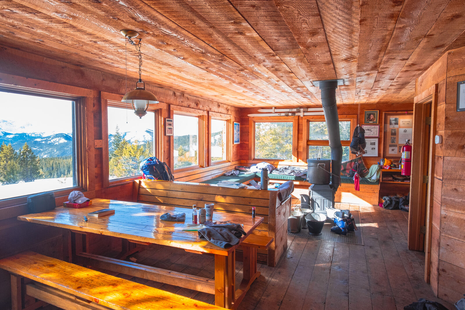 Sunlit timber lodge interior with mountain windows